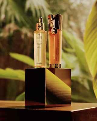 Displayed on a gold block, two products from Guerlin's Abeille Royale range, with repairing honey, catch the light.