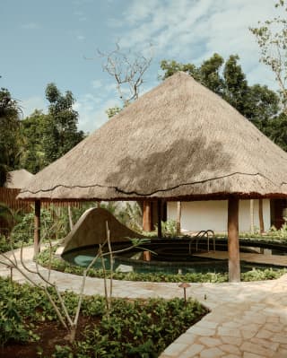 In the grounds of Maroma Spa, a thatched lapa roof held aloft by four posts, provides shade for the cold plunge pool.