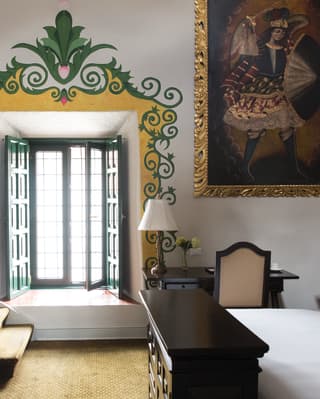 Elegant hotel room with a yellow and green relief around an open window