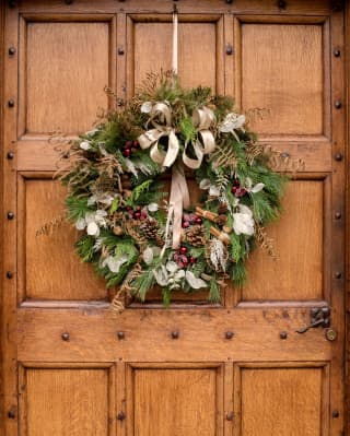 Elegant christmas wreath on an oak door