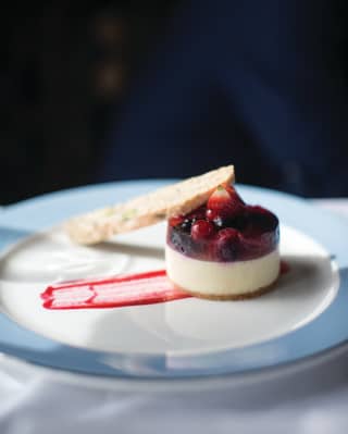 Vanilla panna cotta topped with a summer berry jelly and served with biscotti