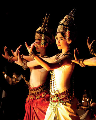 Women dressed in traditional Cambodian garb and performing a dance