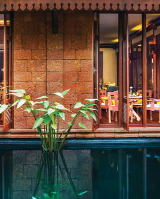 Floor to ceiling windows at Spice Circle Restaurant open out across a pool
