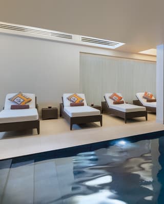 The calm minimalist setting of the spa’s indoor pool creates a relaxed atmosphere