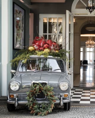 Vintage car with festive decoration parked in front of the hotel's entrance