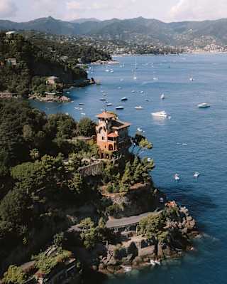 Villa Beatrice stands majestic on a headland that strides into the Gulf of Tigullio in an aerial view along the coast to Rapallo.