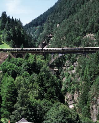Aerial view of a train crossing a rail bridge
