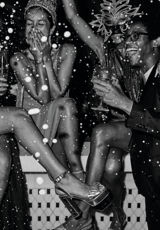 black and white image of people having party splashing champagne
