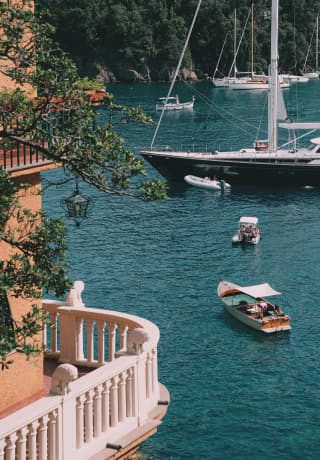 Aerial view of a curved balcony overlooking small fishing boats and yachts