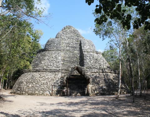The curvaceous stone Xaibe Lookout Tower at the Mayan Ruins in Coba, in a jungle clearing that was once a crossroads.