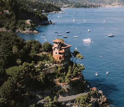 Villa Beatrice stands majestic on a headland that strides into the Gulf of Tigullio in an aerial view along the coast to Rapallo.