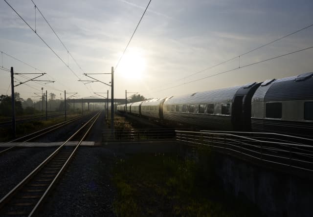 Train tracks and overhead wires are elevated by the scattering of sunrays in Kitajima's romantic portrait of the industrial.