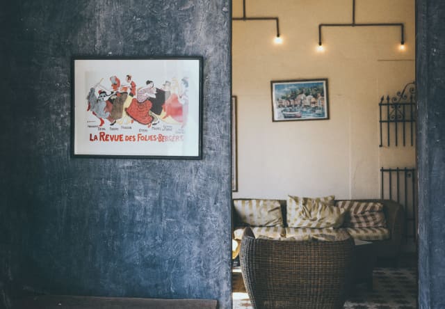 Interior view of atmospheric rooms on Mexico’s Yucatan Peninsula with rough blue painted walls, ceiling fan and tiled floor