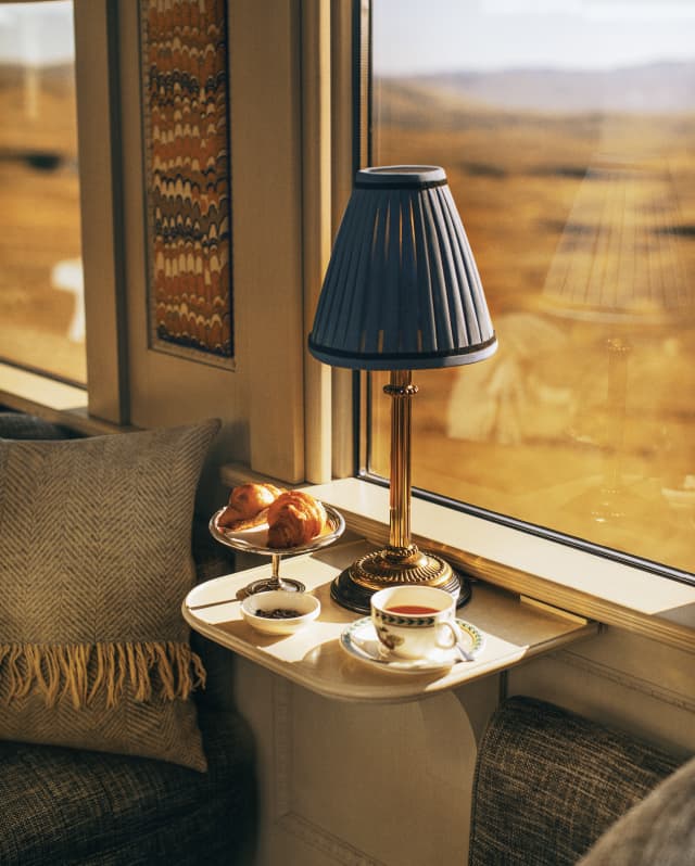 A breakfast on a table by the window in the dining car