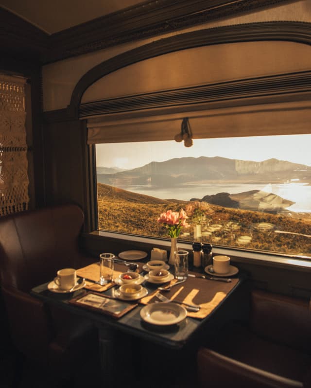 Sunlit cutlery and crockery on a table by the window