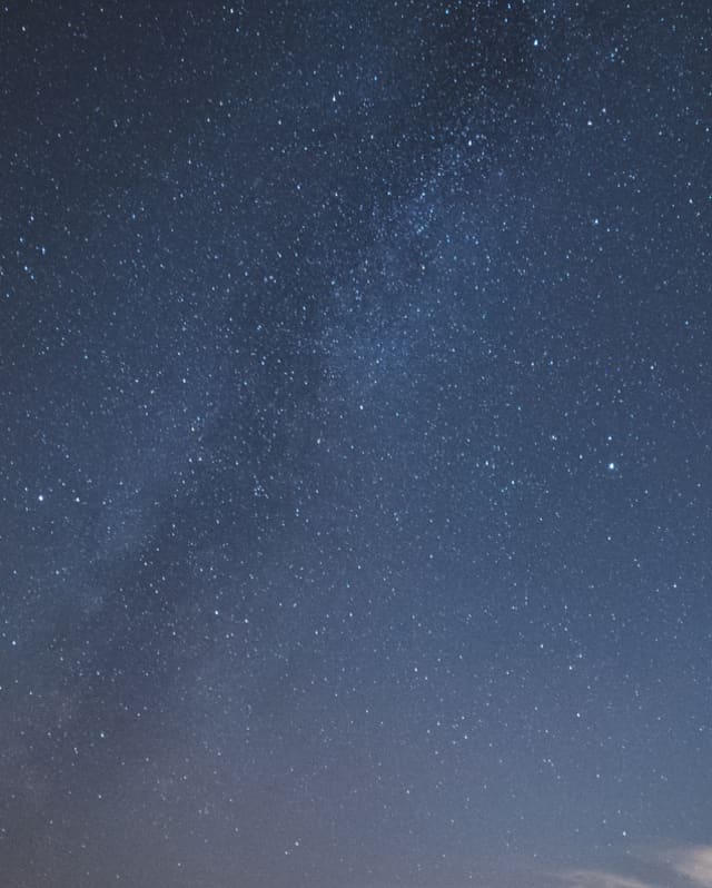 The Milky Way snakes across the heavens, a cloudy ripple in the darkness marking our galaxy among an ocean of stars