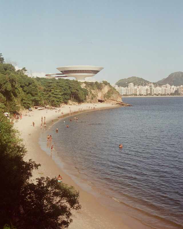 Niterói Contemporary Art Museum's flying-saucer building seen from Boa Viagem bay with views of Icarai neighbourhood beyond.