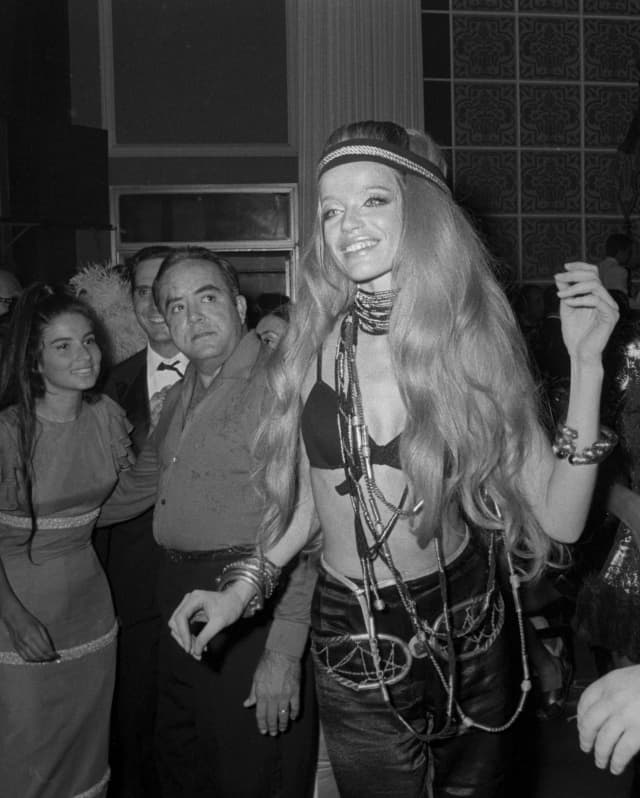 A 1960s image of the German supermodel Veruschka von Lehndorff as she enjoys the carnival party dressed in hippy chic