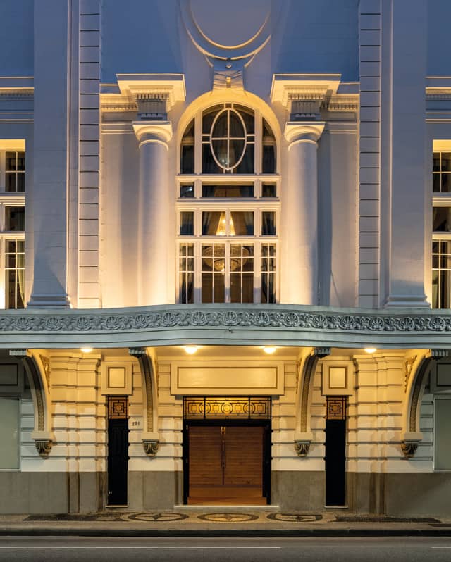 A marble awning and grand pillars mark the entrance to one of Rio's most glamorous venues, the Copacabana Palace Theatre