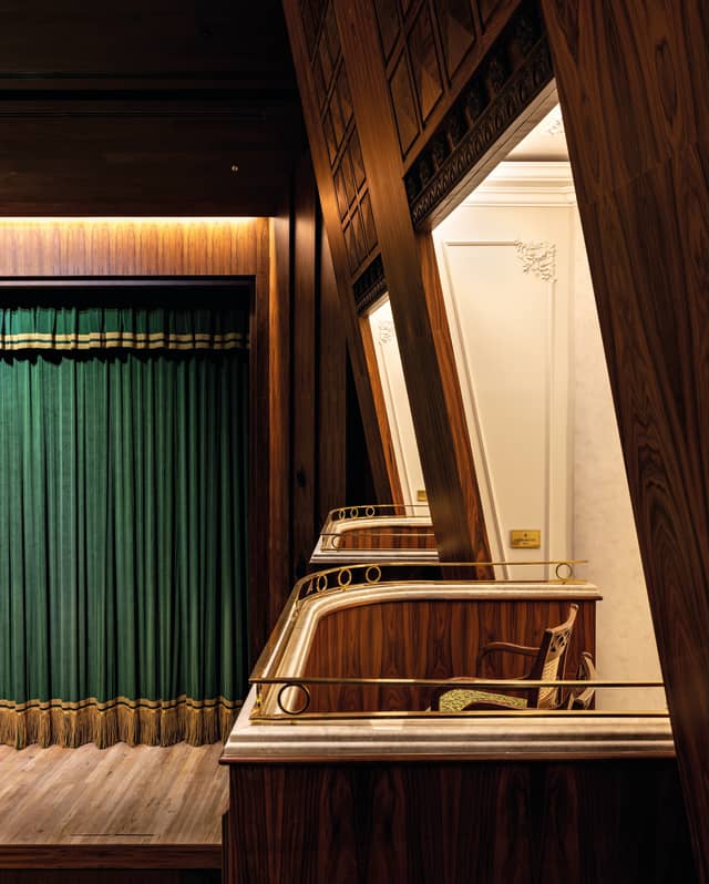 Close-up of two private boxes at the Copacabana Palace Theatre, overlooking the stage with a pleated green safety curtain.