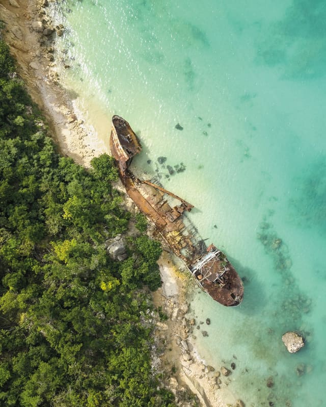 Birds-eye view of a shipwreck in crystal clear waters