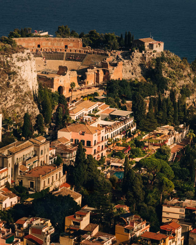 View east of the Ancient Theatre and below it Grand Hotel Timeo, settled into the warm-peach terracotta terraces of Taormina.