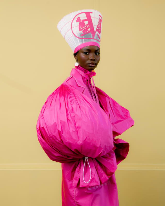 Model Marie Kone wears an electric pink Valentino haute couture dress repurposed as a puff-sleeve coat by Thebe Magugu.