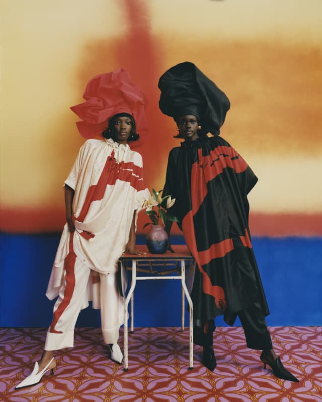 For Thebe Magugu's AZ Factory collaboration shoot, two models wear large hats and tops with trousers in red, white and black.