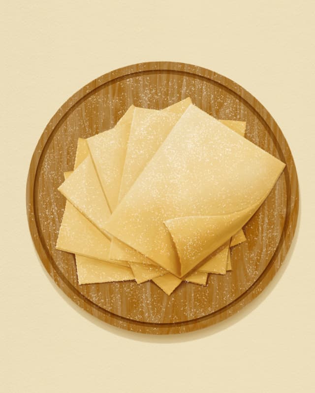Illustration of pasta sheets called Mandilli de Saea, meaning silk handkerchiefs, stacked on a round wood chopping board.