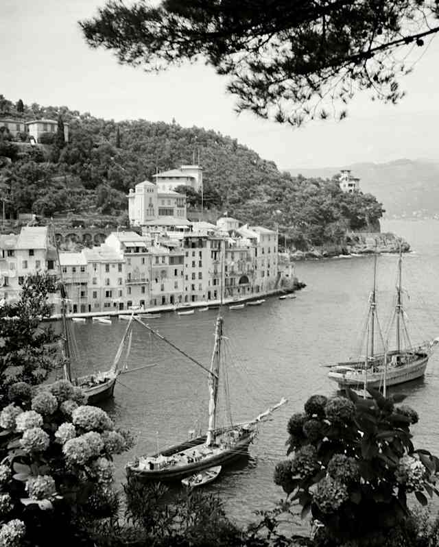 Monochrome image of three sailing boats in Portofino marina, seen in a view from the peninsula to Calata Marconi opposite.