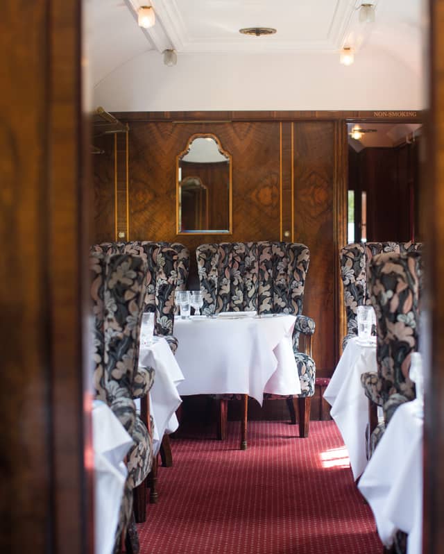 Aisle of an original Pullman carriage with 1950's style marquetry and armchairs