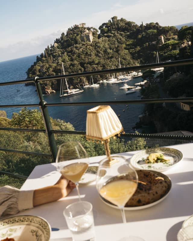 Diners at a table on the terrace of Splendido Grill sit back from their plates and drinks to digest the extraordinary views.