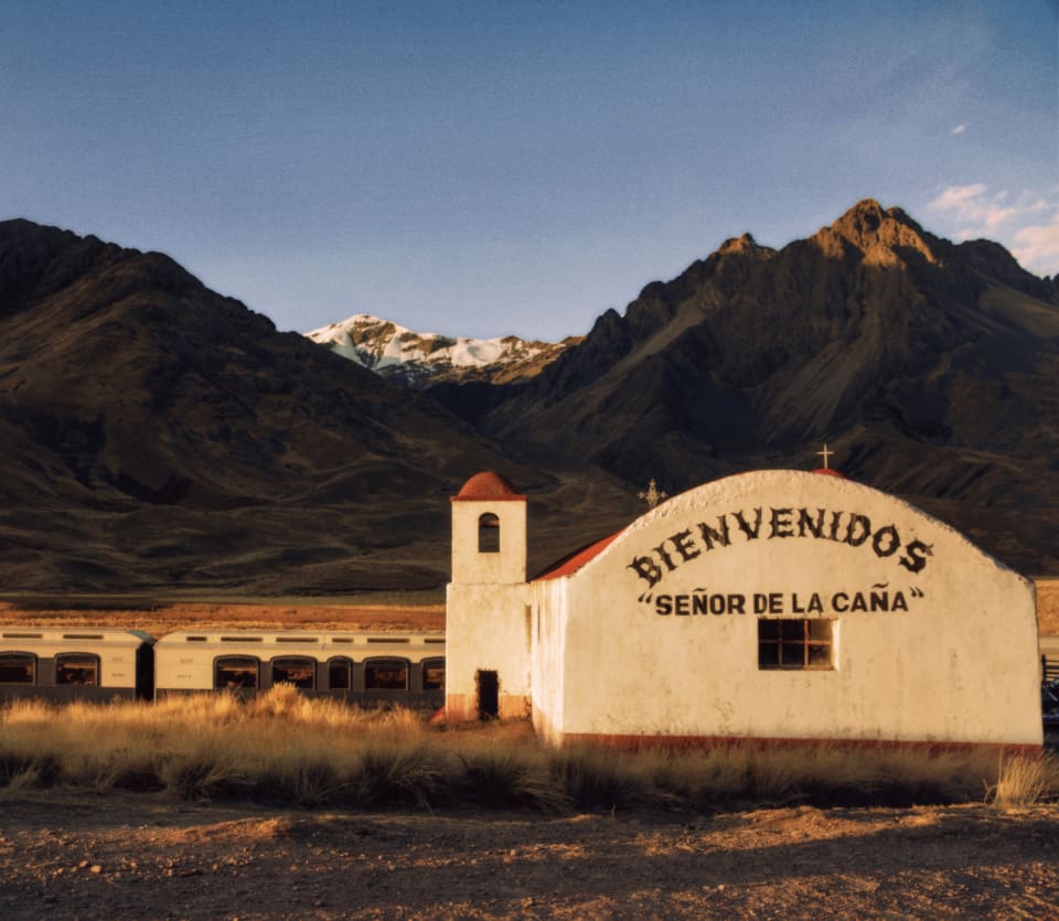 The Andean Explorer stopped near an old church in La Raya with the inscription Bienvenidos 