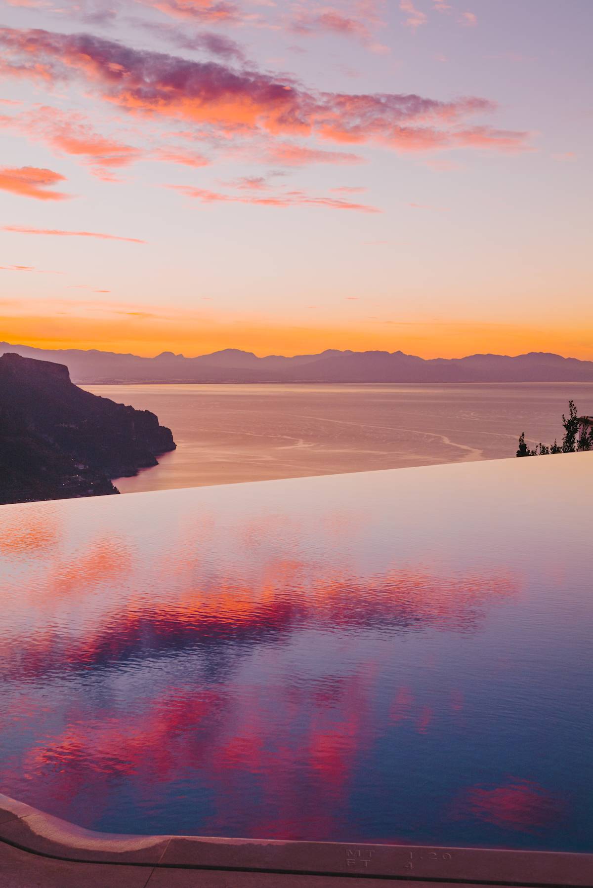 Belmond Hotel Caruso infinity pool at sunset overlooking the Amalfi Coast from Ravello Italy, restored 11th-century palace