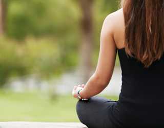 Lady in a lotus yoga pose in a Cape Town garden